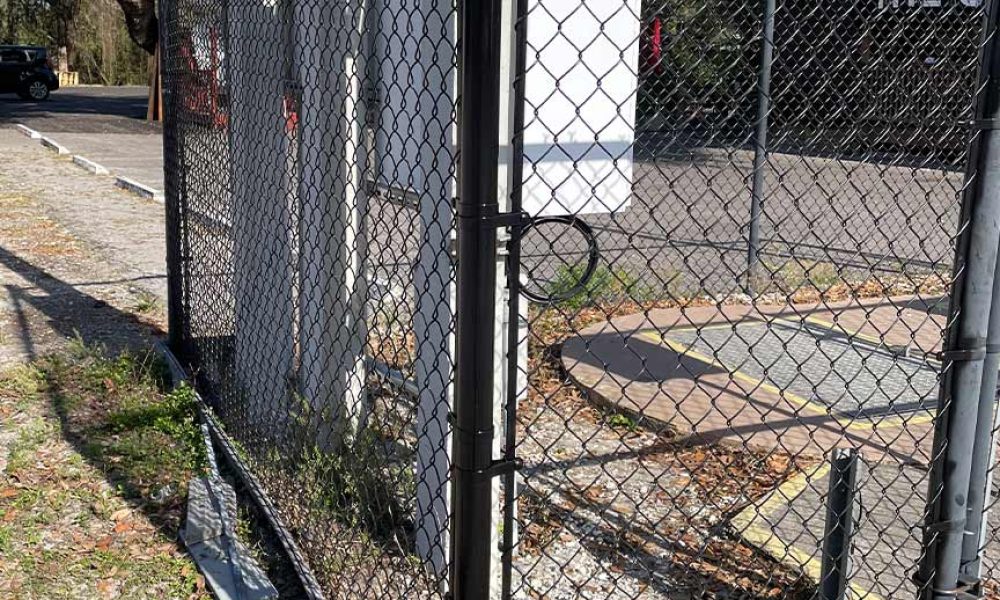 6ft black chain link fence enclosure around utilities equipment