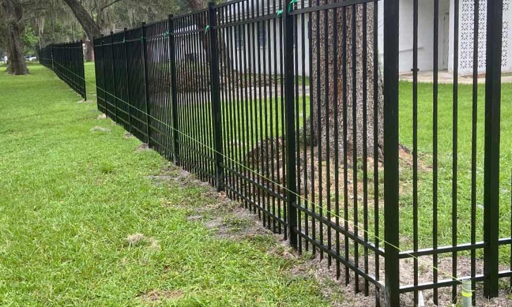 corner perspective of 6ft black aluminum fence being installed